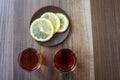 Two piles of whiskey and slices of lemon on a wooden background Royalty Free Stock Photo