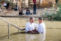Two pilgrims make an oath during the ceremony of baptism on the Baptismal Site of Jesus Christ - Qasr el Yahud in Israel