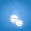 Two pills with bubbles in water Royalty Free Stock Photo