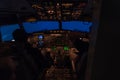 Two pilots sitting in a cockpit of a jet airplane