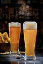 Two Pilsner Glasses with Beer on Bar Royalty Free Stock Photo