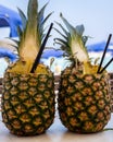 Two pinacolada coctails in fresh pineapple fruit on the bar table. Royalty Free Stock Photo