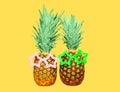 Two pineapple with sunglasses on yellow background Royalty Free Stock Photo