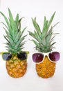 Two pineapples in sunglasses on a white background. Royalty Free Stock Photo