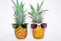 Two pineapples in sunglasses on a white background. Royalty Free Stock Photo