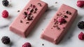 two pink bars of chocolate with raspberries on a marble surface Royalty Free Stock Photo