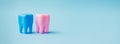 Two pink and blue teeth on a blue background. Dental health concept. Stomatology. Place