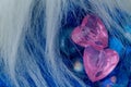 Two pink crystal heart shapes on blue glasses Royalty Free Stock Photo