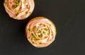 Two pink cup cakes close up on black background - Top view photo Royalty Free Stock Photo