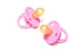 Two pink dummies or pacifiers