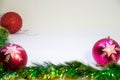 Two pink festive balloons out of focus with a red ball in the corner in focus