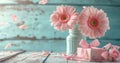 two pink flowers in a vase and gifts on white wood Royalty Free Stock Photo