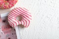 Two pink glazed Donuts covered with sugar crumbs in white background isolated close-up. Valentine's donuts. top view Royalty Free Stock Photo