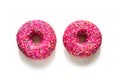 Two pink glazed doughnuts on a white background