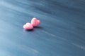 Two pink hearts on dark blue or silver on wooden or metal background. Valentine`s Day Royalty Free Stock Photo