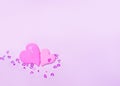 Two pink hearts gently press against each other, on a delicate pink background with sparkles, valentine