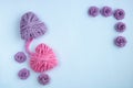 Two pink and lilac hearts made of threads on a white background knitted in one knot