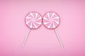 Two Pink Lolipops candy on pastel pink background.