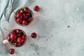 Two pink mugs with fresh ripe cherries. Sweet organic berries on a light concrete background. Top view with copy space Royalty Free Stock Photo