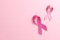 Two pink ribbons isolated on a pink background with copy space for Breast Cancer Awareness Month and World Cancer day. Flyer, Royalty Free Stock Photo