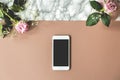 Two pink roses on top view photo of marble table with mockup phone and empty space for your product Royalty Free Stock Photo