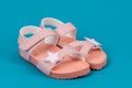 Two pink sandals on blue background. Cute pink sandals for little girl Royalty Free Stock Photo