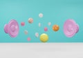 Two pink speakers, complete with balls that are orange, yellow, brown, box, and white coins floating in the air on a blue and Royalty Free Stock Photo