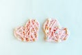 Two pink thread handmade hearts on white background. Royalty Free Stock Photo