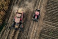 Two Pink Tractors Driving in Field