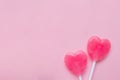 Two Pink Valentine`s day heart shape lollipop candy on empty pastel pink paper background. Love Concept. top view. Royalty Free Stock Photo