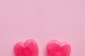 Two Pink Valentine`s day heart shape lollipop candy on empty pink paper background. hipster Minimal Love Concept. top view. Royalty Free Stock Photo