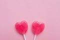 Two Pink Valentine`s day heart shape lollipop candy on empty pink paper background. hipster Minimal Love Concept. top view.