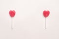 Two Pink Valentine`s day heart shape lollipop candy on empty white paper background. hipster Minimal Love Concept. top view. Royalty Free Stock Photo