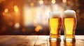 Two pints of beer on a wooden table with bokeh background. Glasses of lager in golden hues. IPA foam. Royalty Free Stock Photo