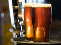 Two pints of dark beer sit on a bar top Royalty Free Stock Photo