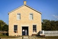 Two Pioneer Women Entering Stone Building