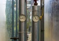 Two pipes with pressure heat meters, modern industrial equipment Royalty Free Stock Photo