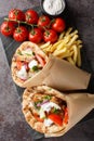 Two pita bread wrapped meat and vegetables closeup on the board on the table. Vertical top view Royalty Free Stock Photo