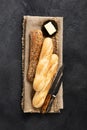 Assorted Baguettes on Burlap with Rustic Knife and Dark Background Royalty Free Stock Photo