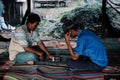 two plain cloths police man playing chess with beer metal cups as playing figures