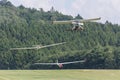 Two sailplanes beeing towed from a motorplane