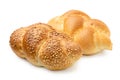 Two plaited white bread rolls isolated on white. Plain and with sesame seeds