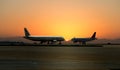 Two planes on the background of sunset at the airport in Attica Greece, April 2015