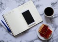 Two planners on marble background, coffee, waffles and smartphone