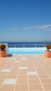 Two planters on a tiled patio overlooking the ocean. Generative AI image. Royalty Free Stock Photo