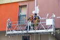 Two plasterers painters performing painting the facade Royalty Free Stock Photo