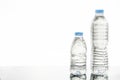Two plastic bottles of water with different sizes. Royalty Free Stock Photo