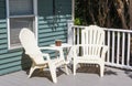 Two plastic chairs in the cornor of a new composite deck Royalty Free Stock Photo