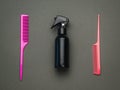 Two plastic combs and a hair spray on a black background. Flat lay Royalty Free Stock Photo