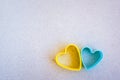 Two plastic hearts together, the color of the Ukrainian flag, blue and yellow. Blank with place for your text Royalty Free Stock Photo